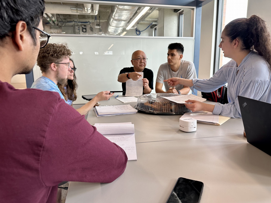Professor at a table with students