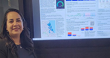 Lizet Casas next to a presentation