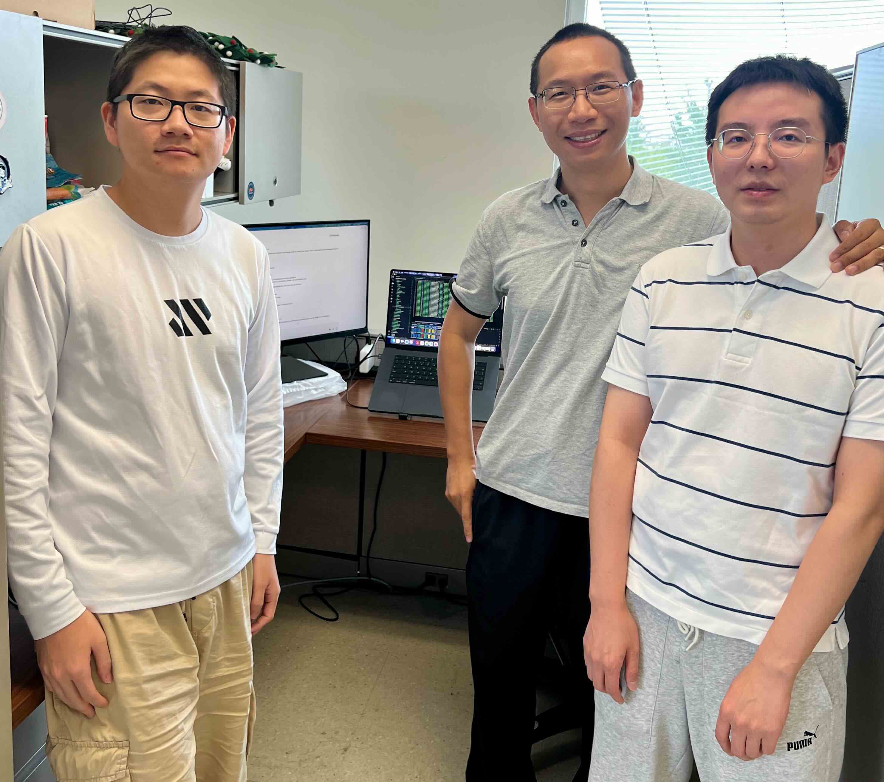 Working with Yuanxiong (Richard) Guo, PhD, center, on AI research made possible by a NVIDIA Academic Grant, are Department of Information Systems and Cybersecurity students Yifan Gao, left, and Jizhong He