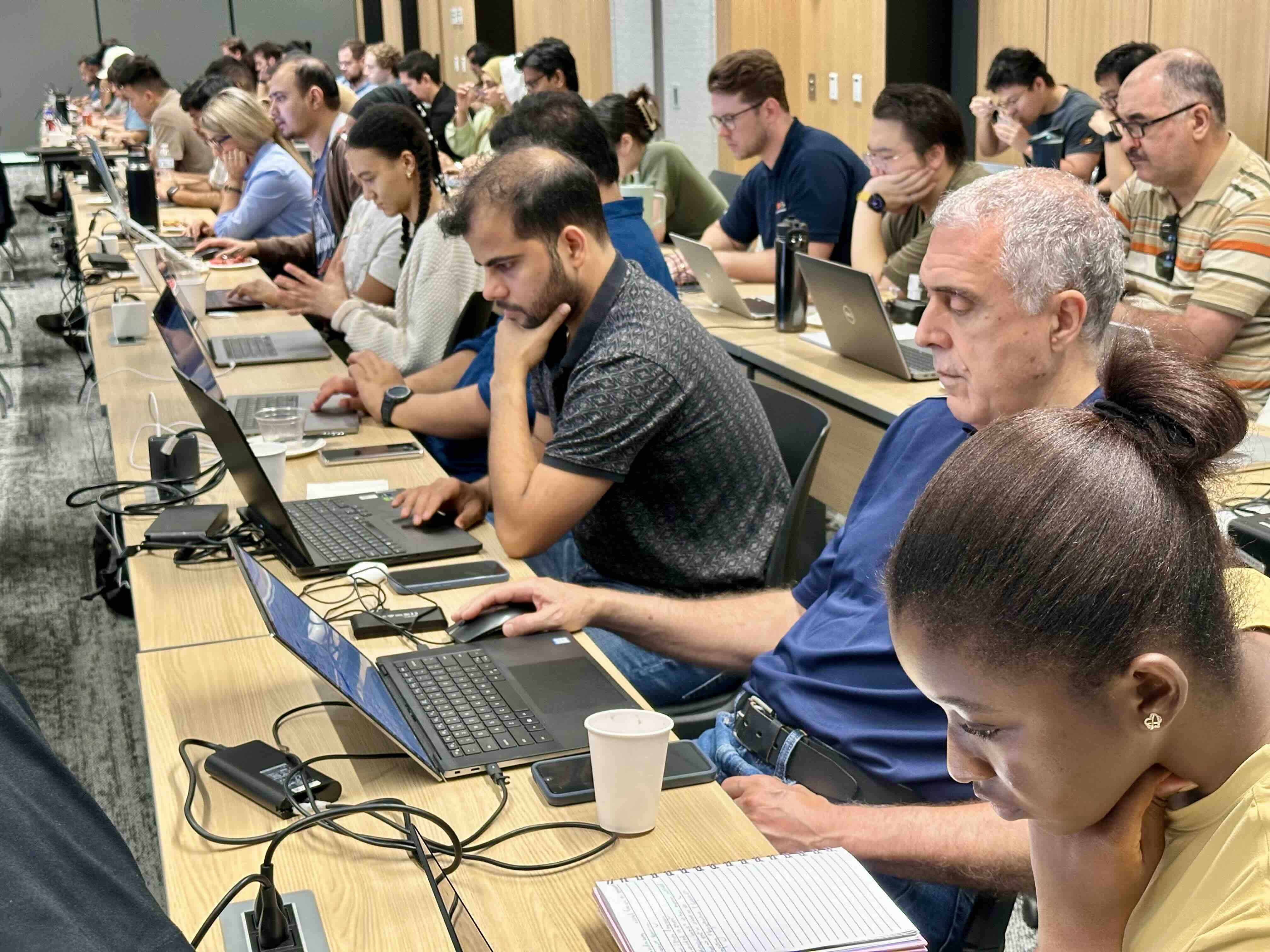 Faculty and students sitting with their laptops