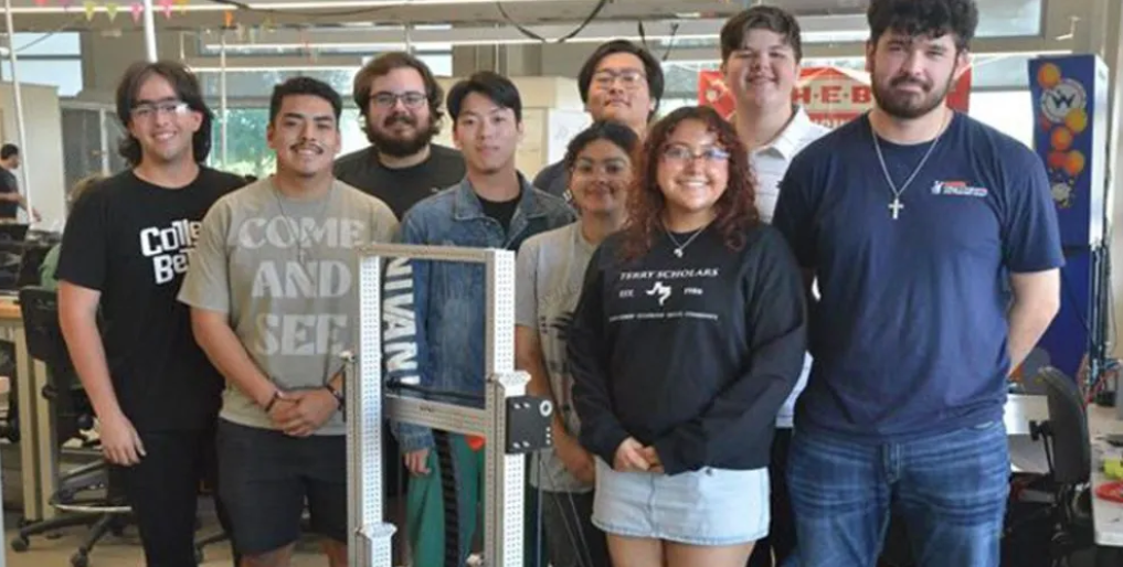 A team of students demonstrating their autonomous robotics project.