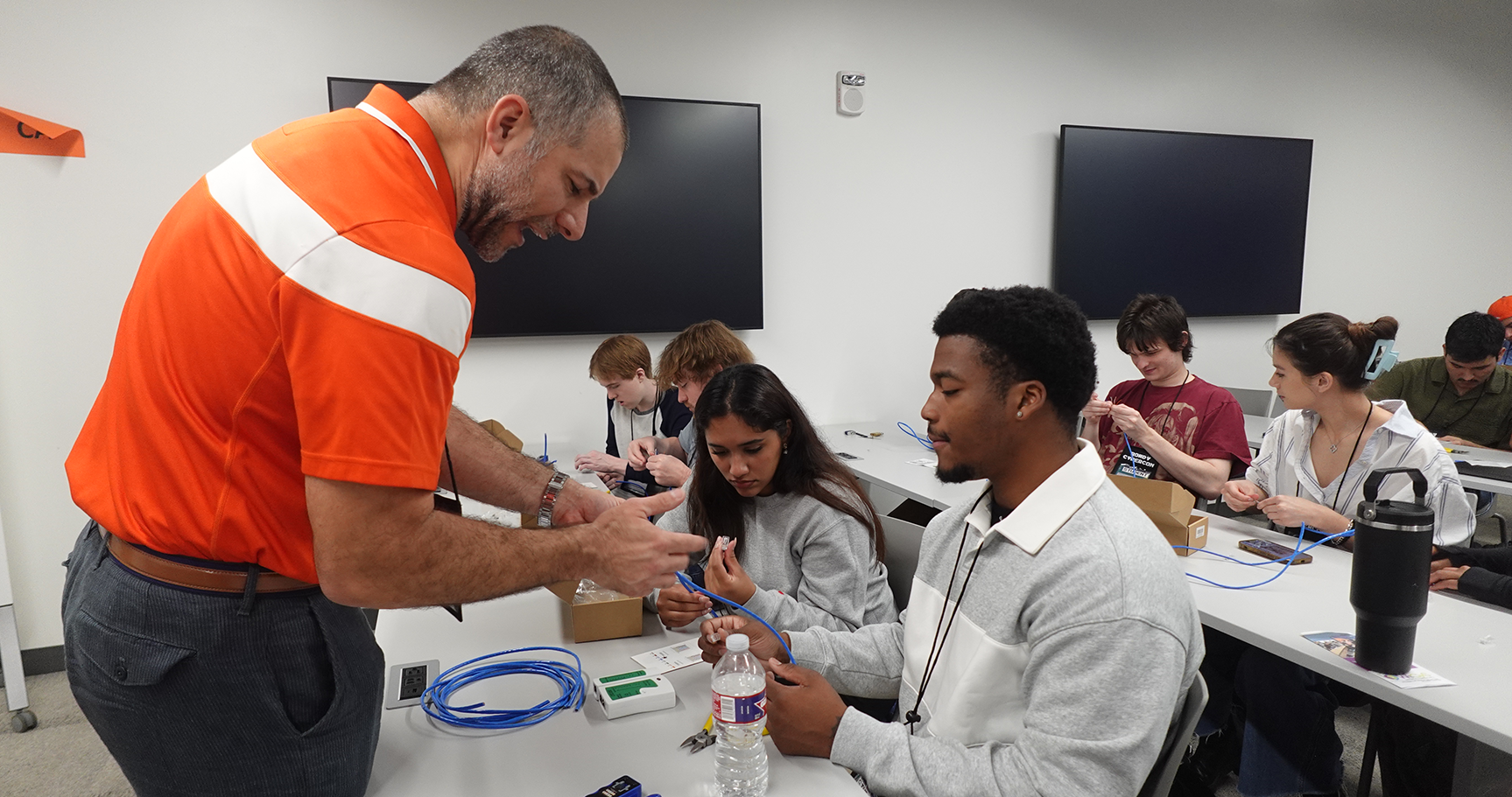 An industry professional talking to a student at Rowdy CyberCon 2025.