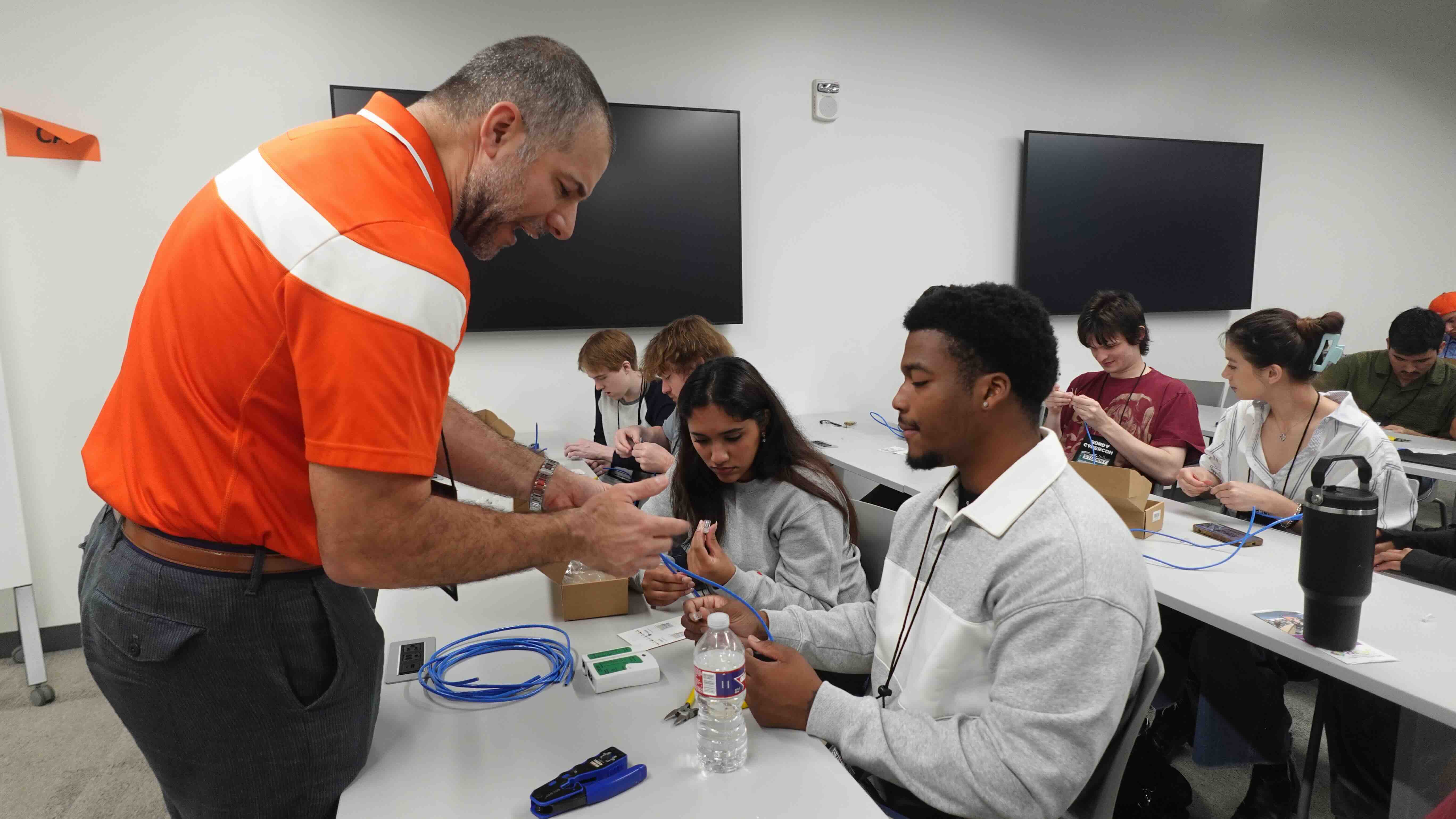 A speaker talks to students at Rowdy CyberCon 2025.