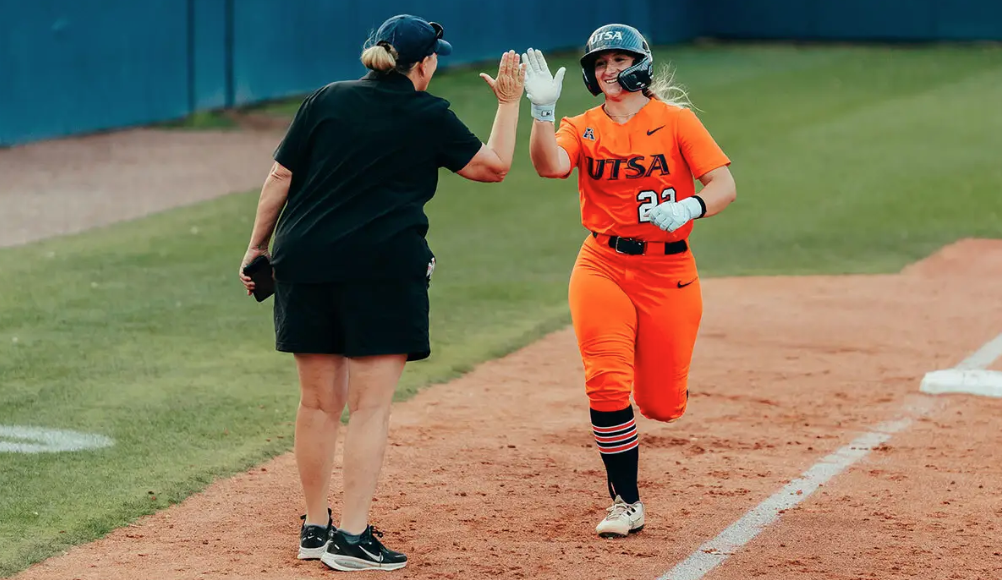 Brookelynn Meador runs to high five softball Head Coach Vann Stuedeman.