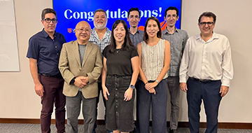 Eight faculty members posing for a picture
